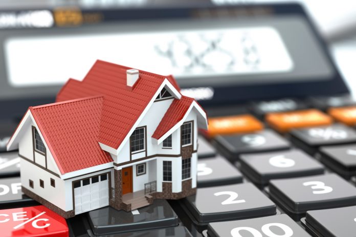 Real estate concept. House on calculator. Mortgage.